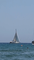Sailboats, swimmers, and an Emirates flight over Larnaca