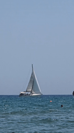 Sailboats, swimmers, and an Emirates flight over Larnaca