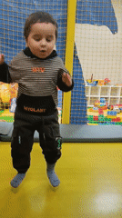 Children play on toy motorcycles in Simferopol indoor space