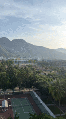 Observer documents sunny Nha Trang cityscape from elevated vantage point