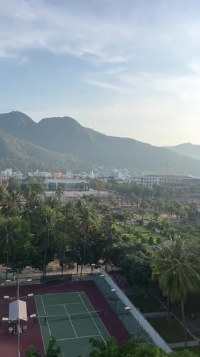 Observer documents sunny Nha Trang cityscape from elevated vantage point