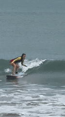 Surfers ride waves off Kuta Selatan beach Indonesia