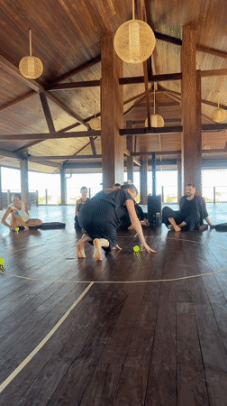 Woman practices tennis ball exercises in Mengwi wooden room