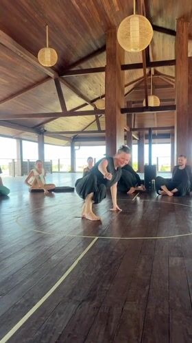 Woman practices tennis ball exercises in Mengwi wooden room