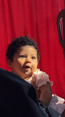 Baby girl photographed smiling while held in Parci, Montenegro