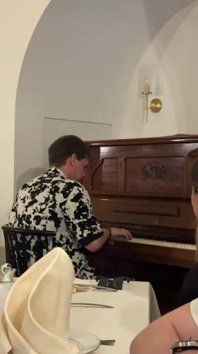 Restaurant pianist performs during dinner service in Minsk