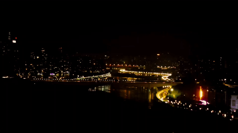 Nighttime cityscape and street cat captured in Yuzhong District