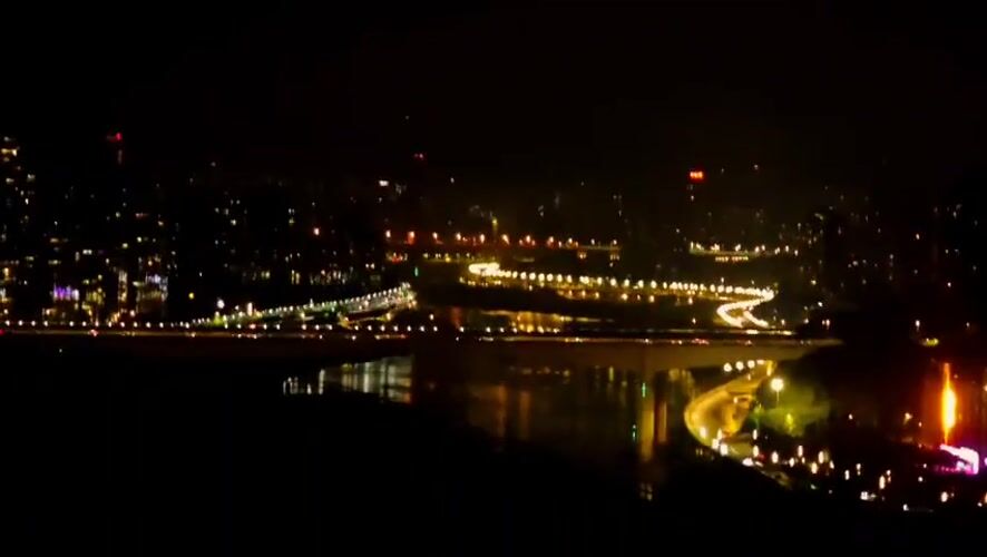 Nighttime cityscape and street cat captured in Yuzhong District