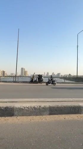 Traffic flows on Cairo waterfront bridge during sunny afternoon