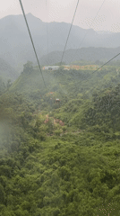 Cable car rider films lush mountain landscape in Đà Nẵng