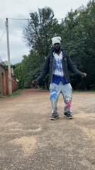 Street dancer performs on roads in Bukuru, Nigeria