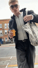 Young man spotted with coffee, takes selfie in London