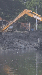 Excavator conducts water construction work at Indonesian reservoir