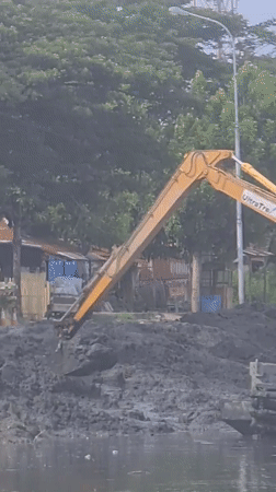 Excavator conducts water construction work at Indonesian reservoir