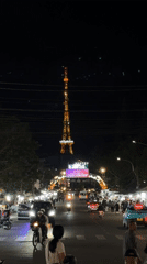 Evening street life bustles around Vinaphone tower in Da Lat