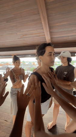 Group fitness session held in wooden pavilion in Mengwi