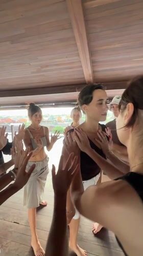 Group fitness session held in wooden pavilion in Mengwi