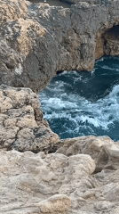 Afternoon at El Miracle's clifftop saint statue and rocky coast