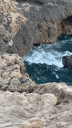Afternoon at El Miracle's clifftop saint statue and rocky coast