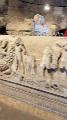 Tourist documents ancient marble artifacts at Pamukkale archaeological site