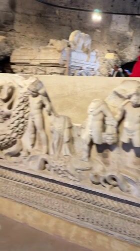 Tourist documents ancient marble artifacts at Pamukkale archaeological site