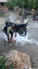 Motorcycle washing activity observed in Dar es Salaam neighborhood