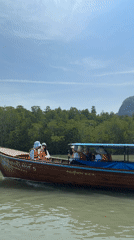 Longtail boats cruise Thailand waters with passengers aboard