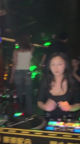 Female DJ performs at crowded Liangjiang nightclub