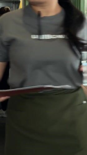 Woman carries small poodle in bag in Mengwi