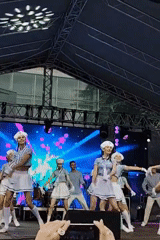 Street festival features folk dancers, stilt performers, giant inflatable giraffe
