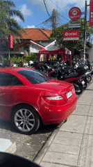Red Mercedes convertible spotted in bustling North Kuta street