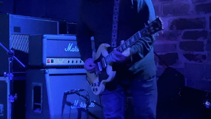 Live guitar performance captured at Milan venue