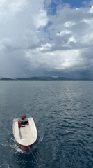 Dinghy towed behind vessel in Indonesian waters near Labuan Bajo