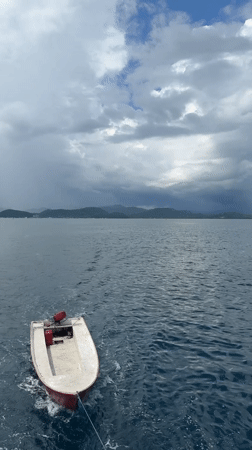 Dinghy towed behind vessel in Indonesian waters near Labuan Bajo