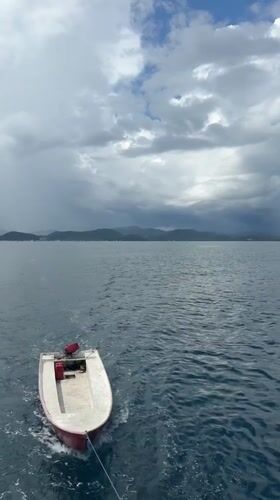 Dinghy towed behind vessel in Indonesian waters near Labuan Bajo