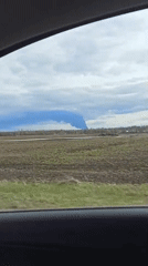 Smoke plume observed from moving vehicle in rural area