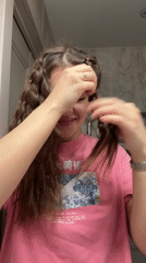 Woman styles hair, takes selfies in Moscow bathroom