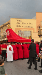 Religious procession with ornate floats moves through Málaga streets