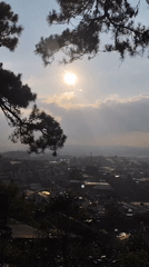 Morning sunlight illuminates Xuân Thành cityscape through clouds