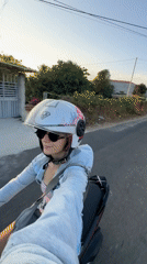 Woman films herself while riding scooter in Mũi Né