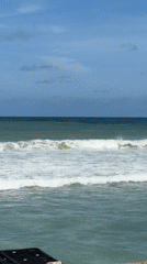 Waves rolling in at Patong Beach on a clear day