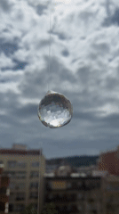Crystal ball creates light patterns through Barcelona window