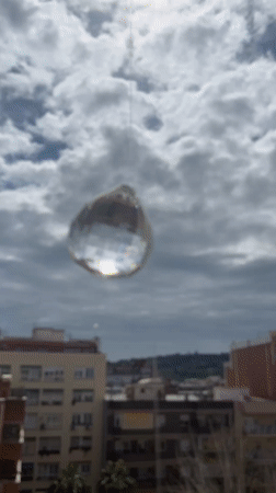 Crystal ball creates light patterns through Barcelona window