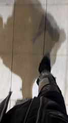 Person in distressed pants walks on tiled surface in Buenos Aires