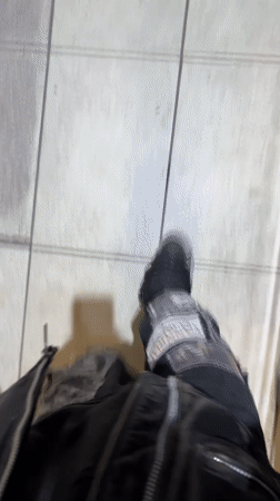 Person in distressed pants walks on tiled surface in Buenos Aires