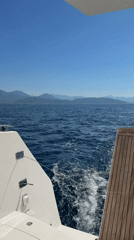 White boat cruises blue waters off Cetara, Italy