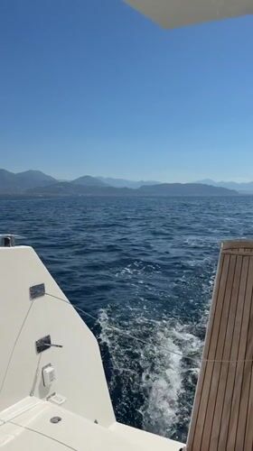 White boat cruises blue waters off Cetara, Italy