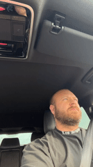 Behind the wheel in Chaikovsky, rocking a Los Angeles tee