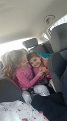 Two girls in pink shirts spotted in car backseat