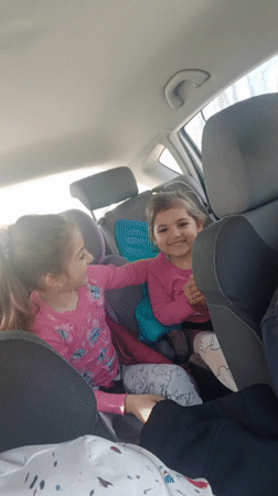Two girls in pink shirts spotted in car backseat